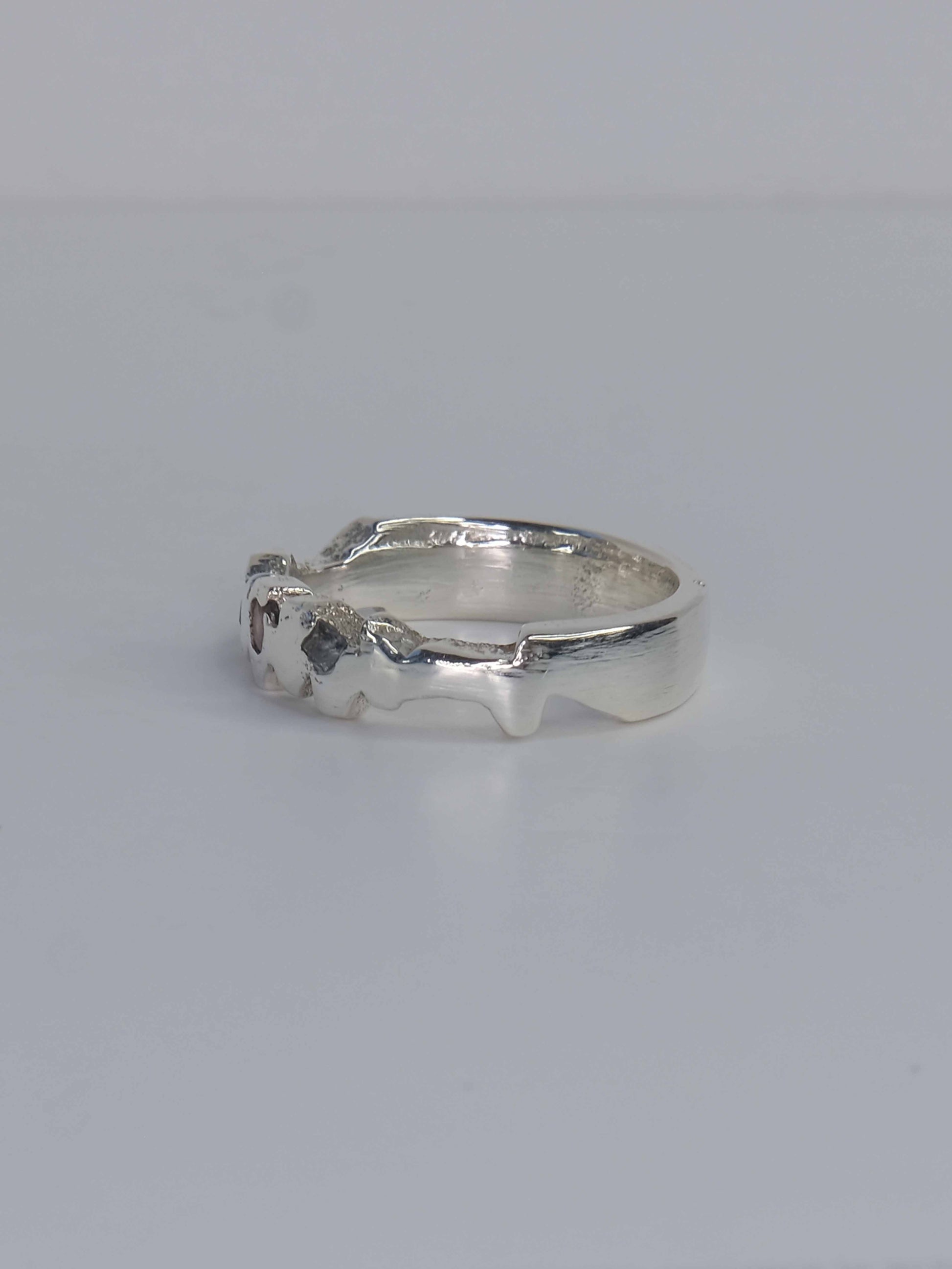 Tankwa Ring aus 925 Sterling-Silber mit strukturierten Oberflächen, die an die scharfen Wüstensteine des Tankwa Karoo Nationalparks erinnern. Verziert mit kleinen quadratischen Saphiren in verschiedenen Blau- und Lilatönen. Handgefertigt und designed in Berlin.